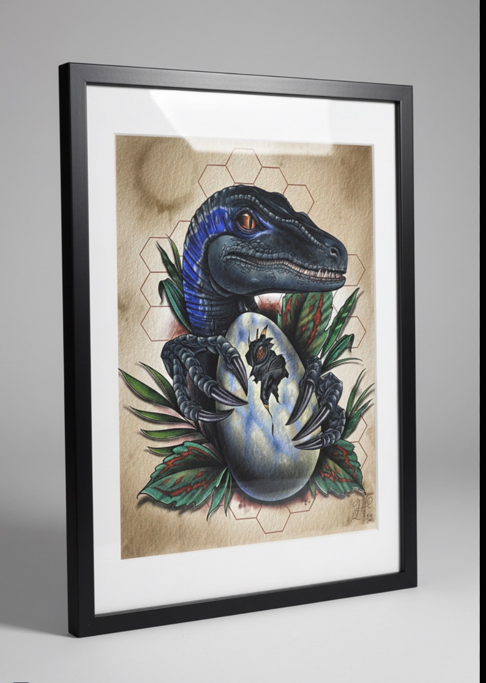 Framed artwork of a dinosaur and egg on a textured background